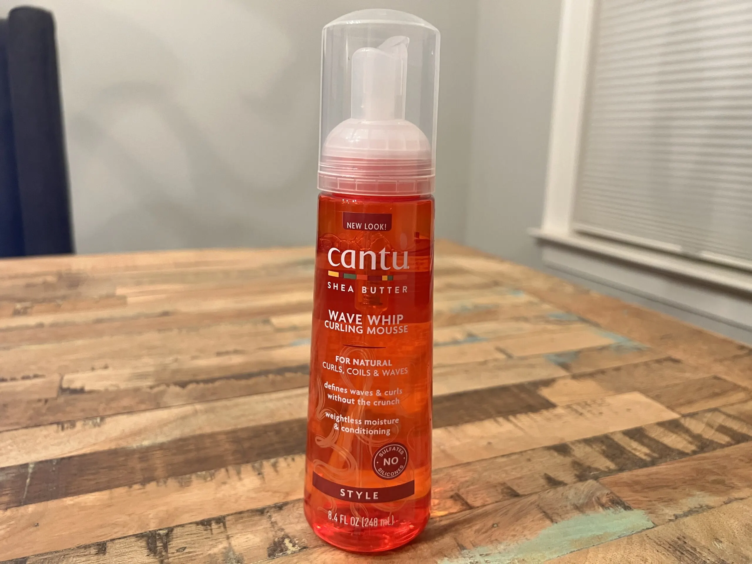 Cantu Shea Butter Wave Whip Curling Mousse can, formulated to define and enhance natural curl patterns.