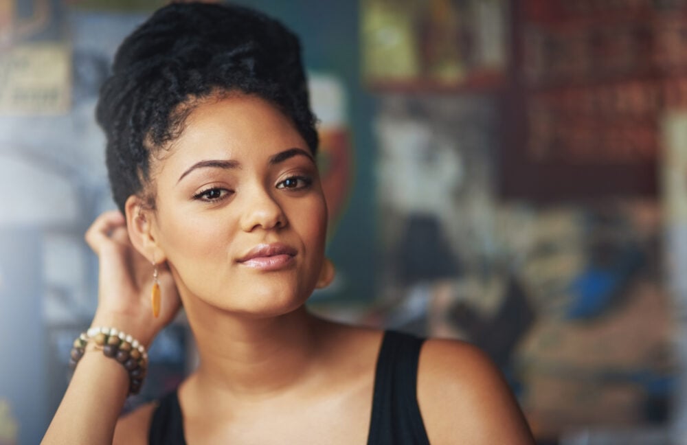 Black woman with her twisted hair pinned into a loose updo off her neck
