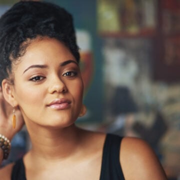 Black woman with her twisted hair pinned into a loose updo off her neck